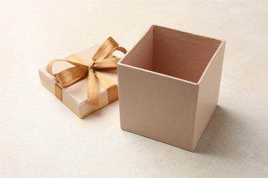 Photo of Open gift box with beautiful lid on light background