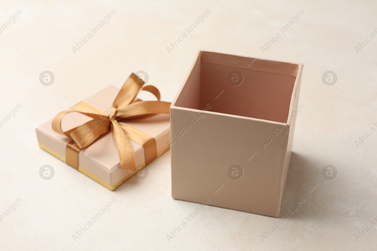 Photo of Open gift box with beautiful lid on light background