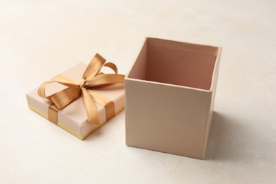 Photo of Open gift box with beautiful lid on light background