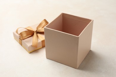 Photo of Open gift box with beautiful lid on light background