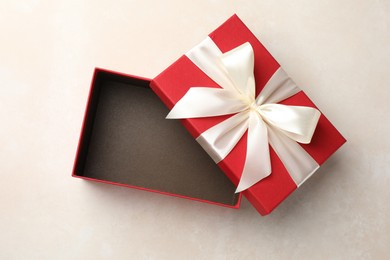 Photo of Open gift box with beautiful lid on light background, top view