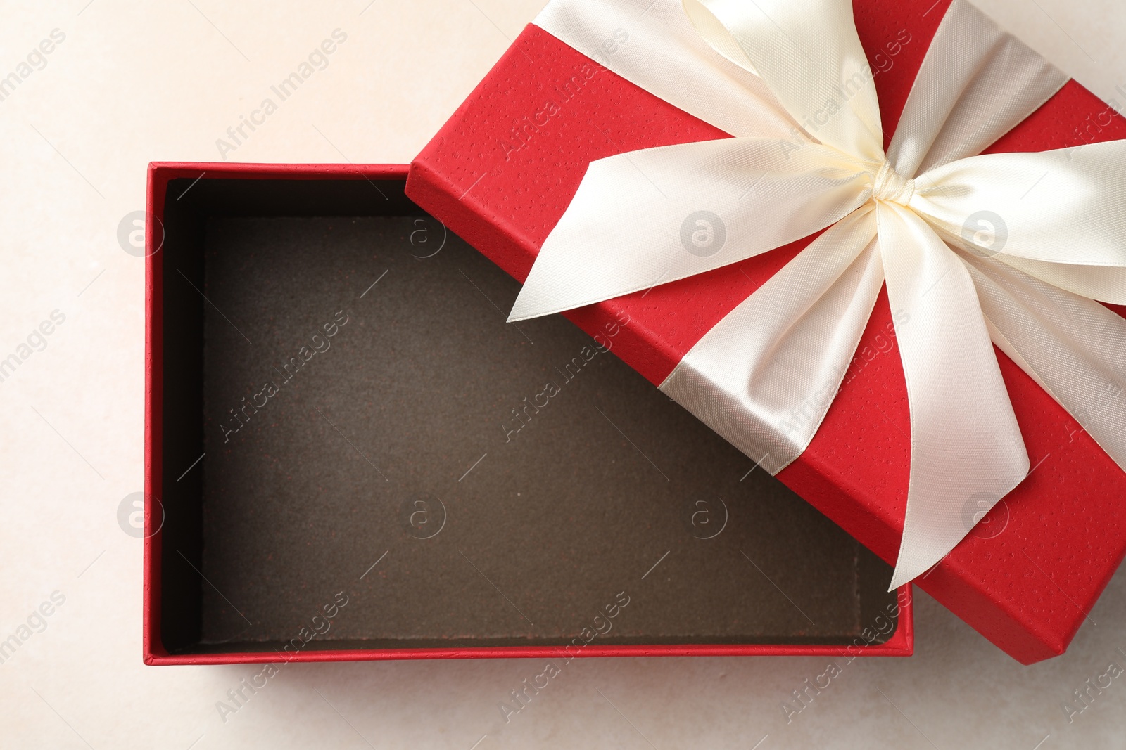 Photo of Open gift box with beautiful lid on light background, top view