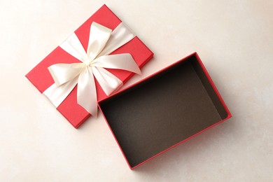 Photo of Open gift box with beautiful lid on light background, top view