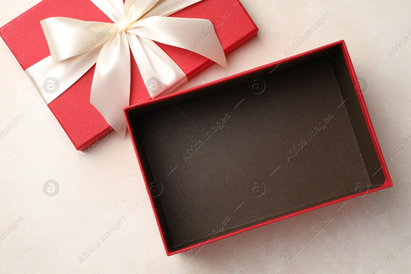Photo of Open gift box with beautiful lid on light background, top view