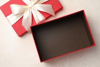 Photo of Open gift box with beautiful lid on light background, top view