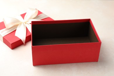 Photo of Open gift box with beautiful lid on light background
