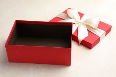 Photo of Open gift box with beautiful lid on light background