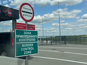 Photo of Malhowice-Nyzhankovychi, Ukraine, Poland - June 21, 2025: Border checkpoint with signs at Polish-Ukrainian crossing