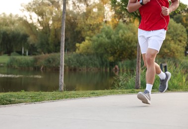 Photo of Man running in park, closeup. Space for text