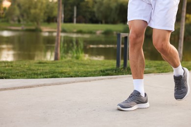 Photo of Man running in park, closeup. Space for text
