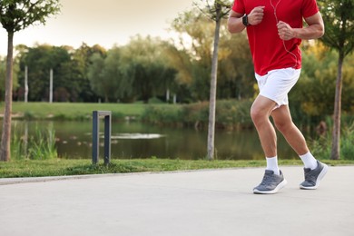 Photo of Man running in park, closeup. Space for text