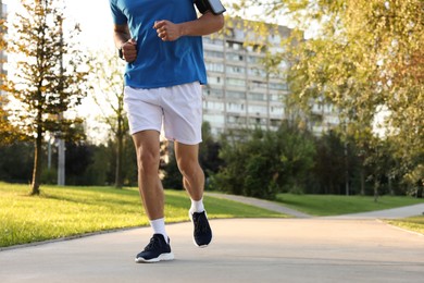 Photo of Man running in park, closeup. Space for text