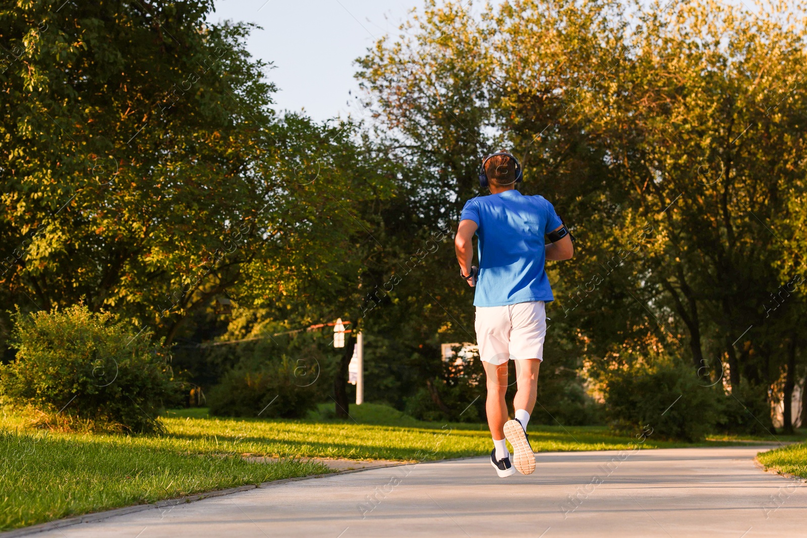 Man running in park on sunny day, low angle view Photo of Man running in park on sunny day, low angle view