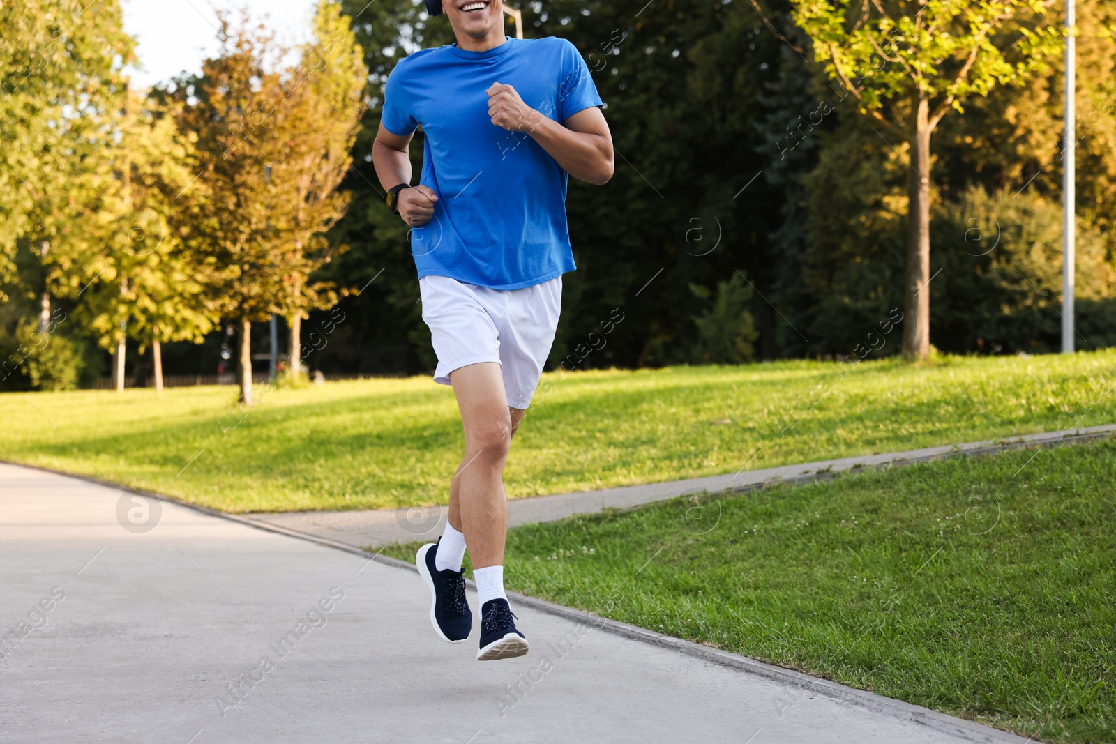 Man running in park on sunny day, closeup Photo of Man running in park on sunny day, closeup