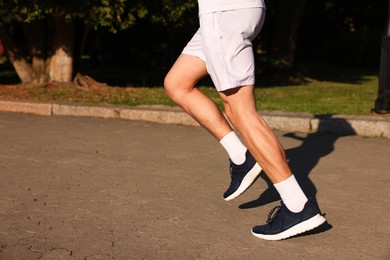 Photo of Man in stylish sneakers outdoors, closeup. Space for text