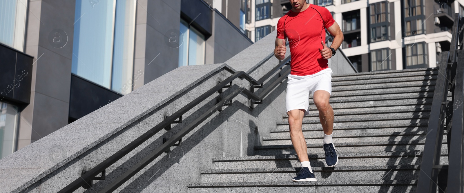 Man in sportswear running down on stairs outdoors, closeup Photo of Man in sportswear running down on stairs outdoors, closeup
