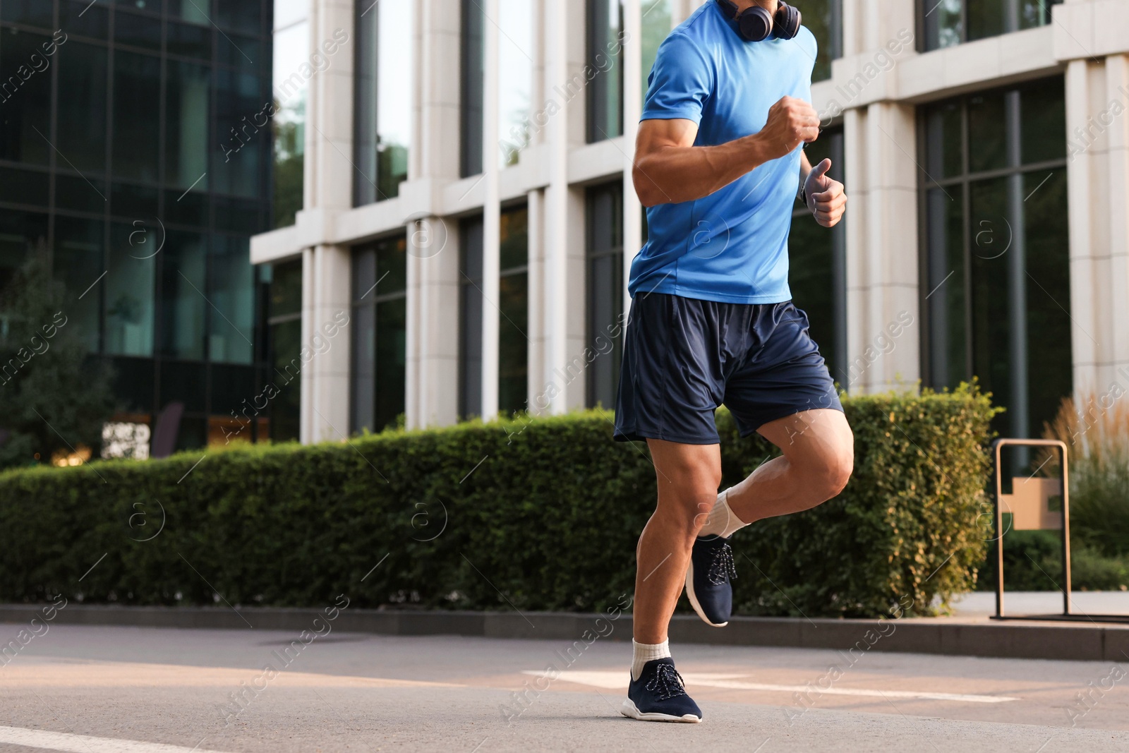 Photo of Man in sportswear running on city street, closeup. Space for text