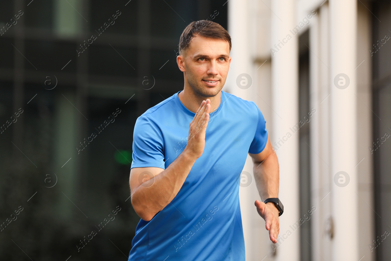 Photo of Man in sportswear running on city street
