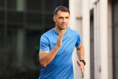 Photo of Man in sportswear running on city street