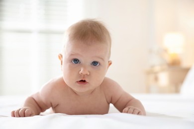 Photo of Portrait of cute baby after bathing on bed, closeup