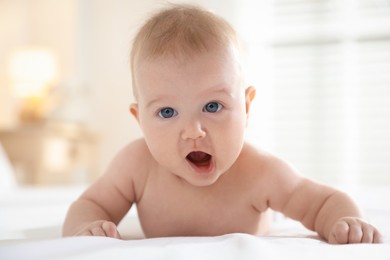 Photo of Cute baby after bathing on bed, closeup