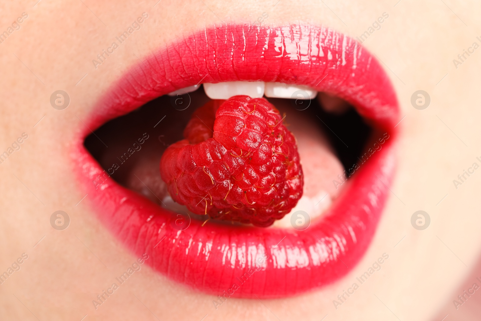 Woman with beautiful lips makeup and raspberry, closeup Photo of Woman with beautiful lips makeup and raspberry, closeup