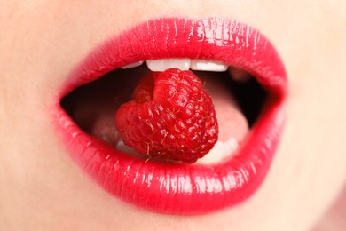 Photo of Woman with beautiful lips makeup and raspberry, closeup