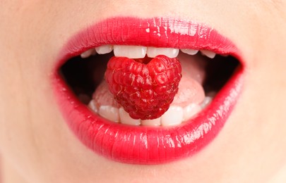 Photo of Woman with beautiful lips makeup and raspberry, closeup