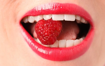 Photo of Woman with beautiful lips makeup and raspberry, closeup