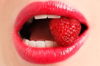 Photo of Woman with beautiful lips makeup and raspberry, closeup