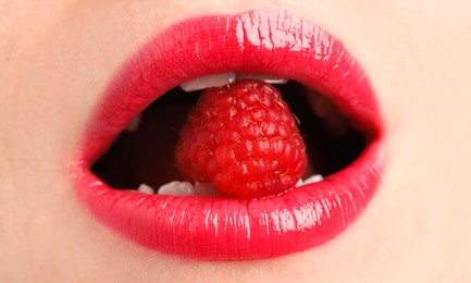 Photo of Woman with beautiful lips makeup and raspberry, closeup