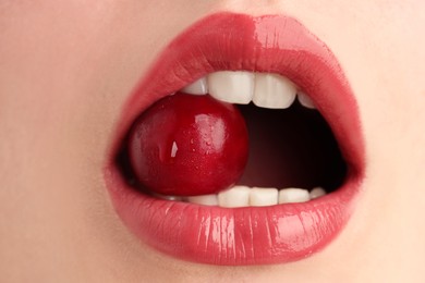 Photo of Woman with beautiful lips makeup and cherry, closeup