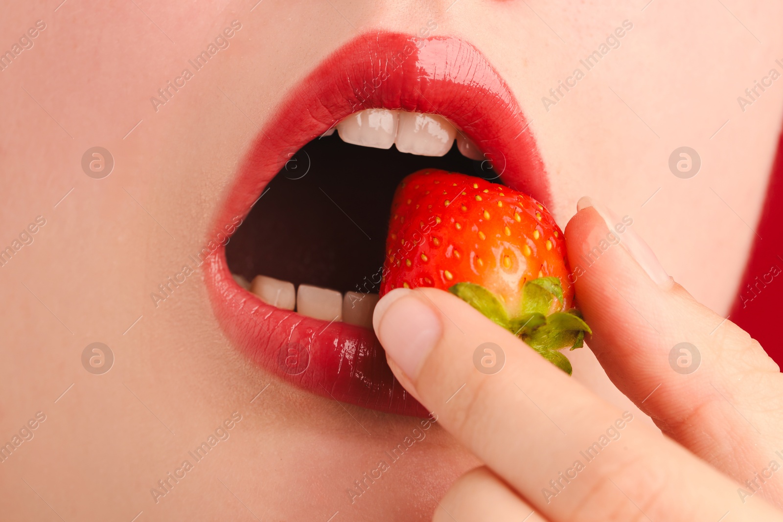 Woman with beautiful lips makeup and strawberry, closeup Photo of Woman with beautiful lips makeup and strawberry, closeup