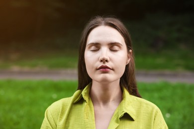Photo of Woman meditating to heal or restore her aura in nature