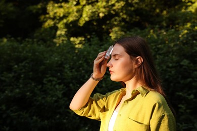 Photo of Woman meditating with crystal to heal or restore her aura outdoors