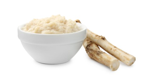 Photo of Tasty horseradish sauce in bowl and roots isolated on white
