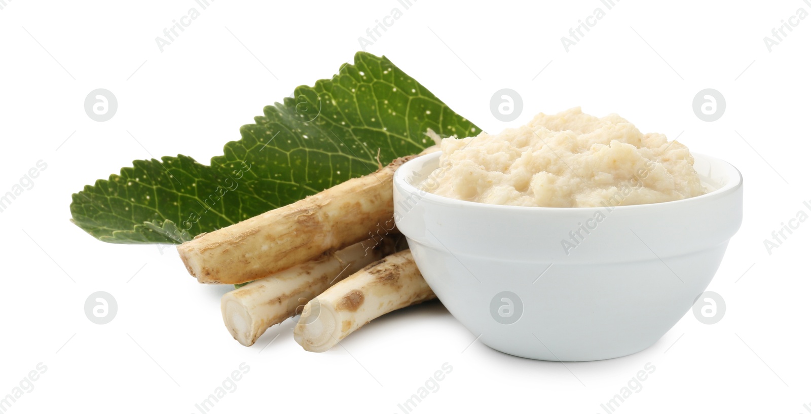 Photo of Tasty horseradish sauce in bowl, roots and leaf isolated on white