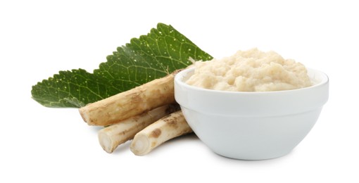 Photo of Tasty horseradish sauce in bowl, roots and leaf isolated on white