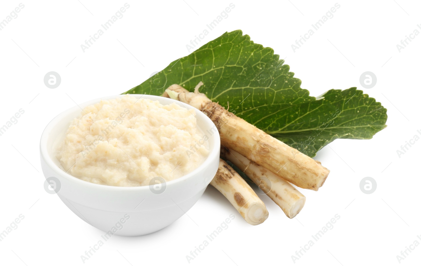 Photo of Tasty horseradish sauce in bowl, roots and leaf isolated on white