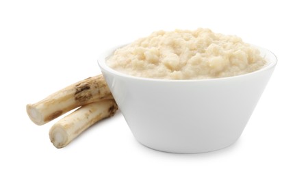 Photo of Tasty horseradish sauce in bowl and roots isolated on white