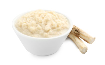 Photo of Tasty horseradish sauce in bowl and roots isolated on white