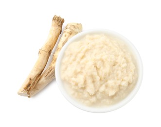 Photo of Tasty horseradish sauce in bowl and roots isolated on white, top view
