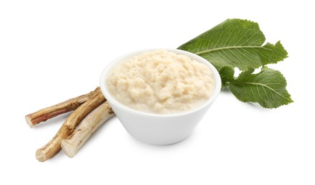 Photo of Tasty horseradish sauce in bowl, roots and leaves isolated on white