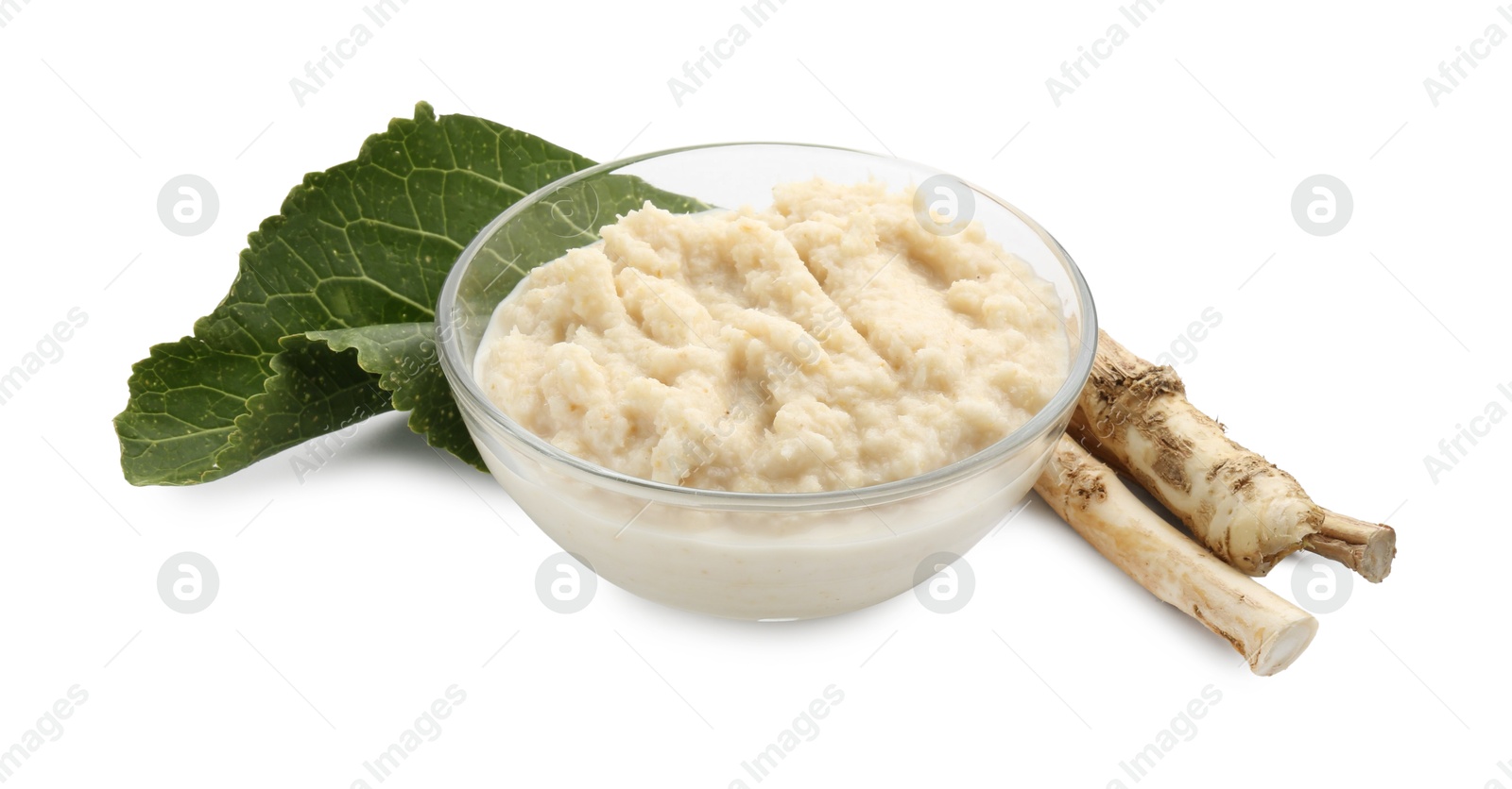 Photo of Tasty horseradish sauce in bowl, roots and leaf isolated on white