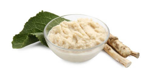 Photo of Tasty horseradish sauce in bowl, roots and leaf isolated on white