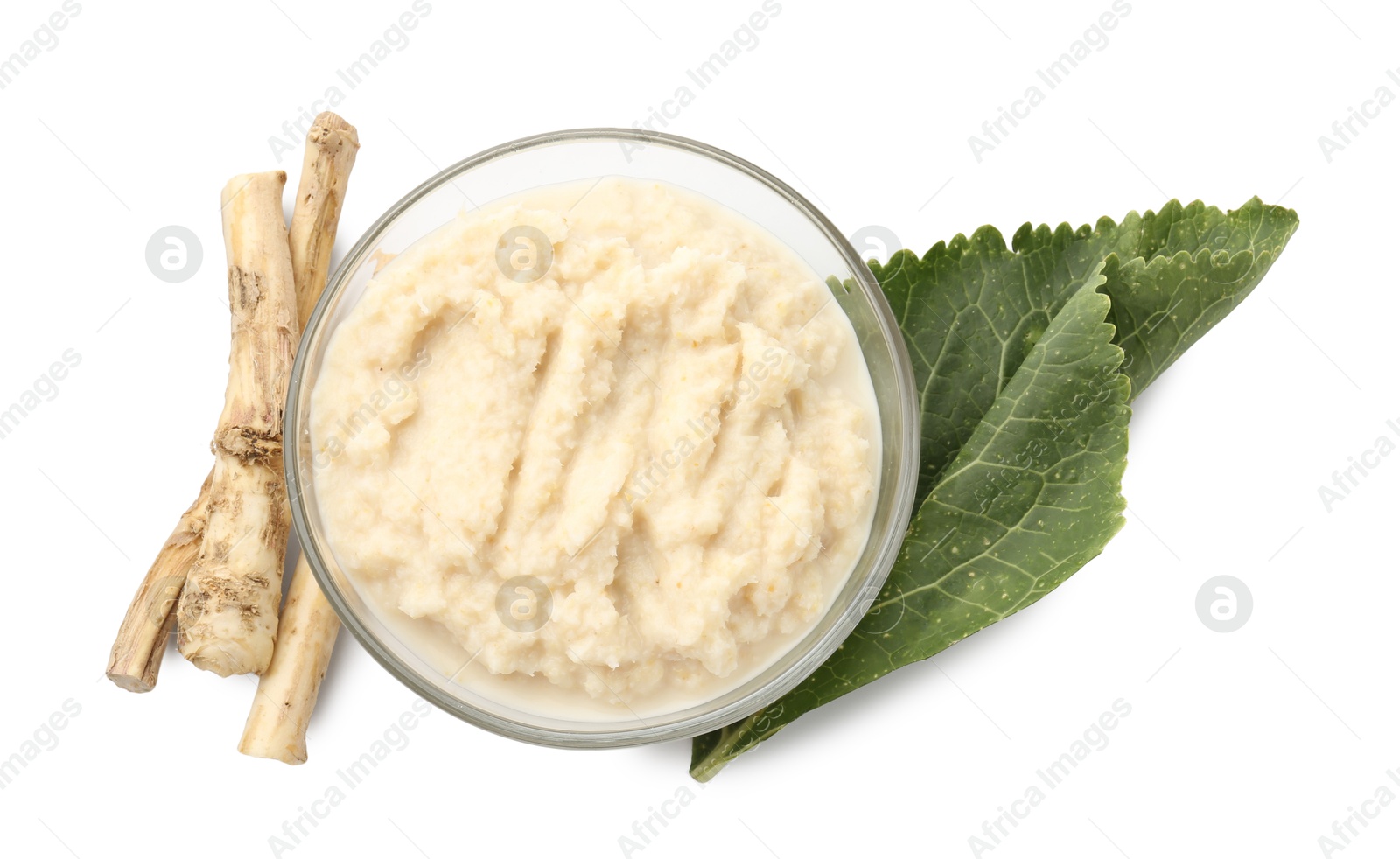 Photo of Tasty horseradish sauce in bowl, roots and leaf isolated on white, top view