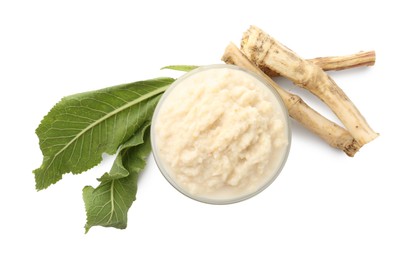 Photo of Tasty horseradish sauce in bowl, roots and leaves isolated on white, top view