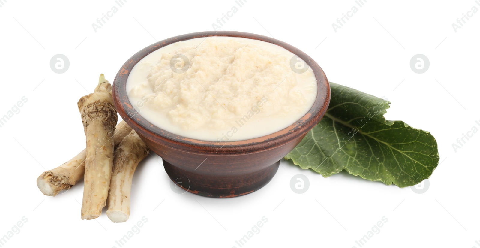 Photo of Tasty horseradish sauce in bowl, roots and leaf isolated on white