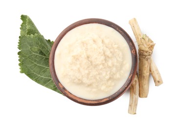 Photo of Tasty horseradish sauce in bowl, roots and leaf isolated on white, top view