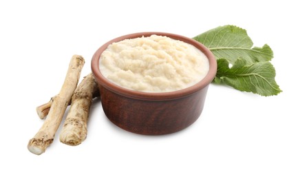 Photo of Tasty horseradish sauce in bowl, roots and leaves isolated on white